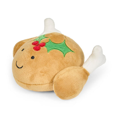 Plush toy resembling a turkey with holly leaves and berries looking from the right